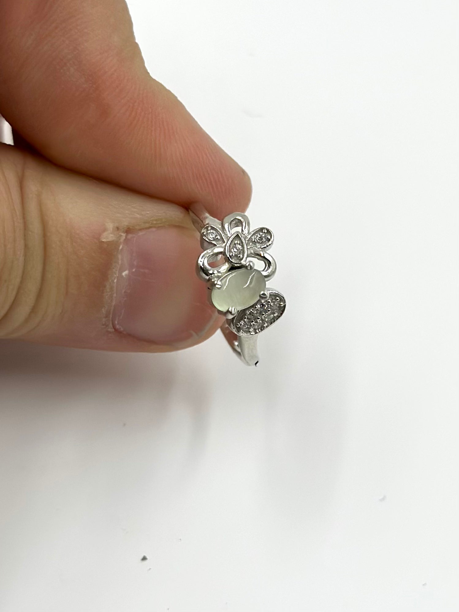 Zircon studded with a green stone, flower shaped sterling silver artisanal ring