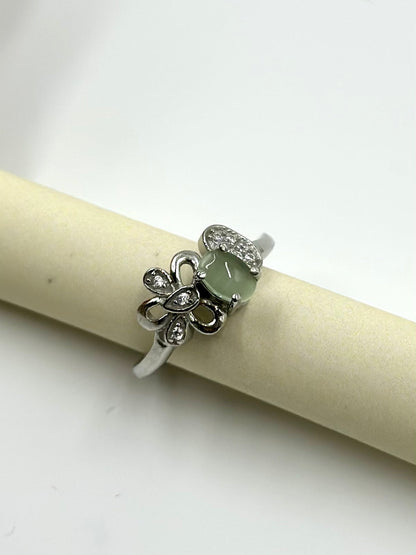 Zircon studded with a green stone, flower shaped sterling silver artisanal ring
