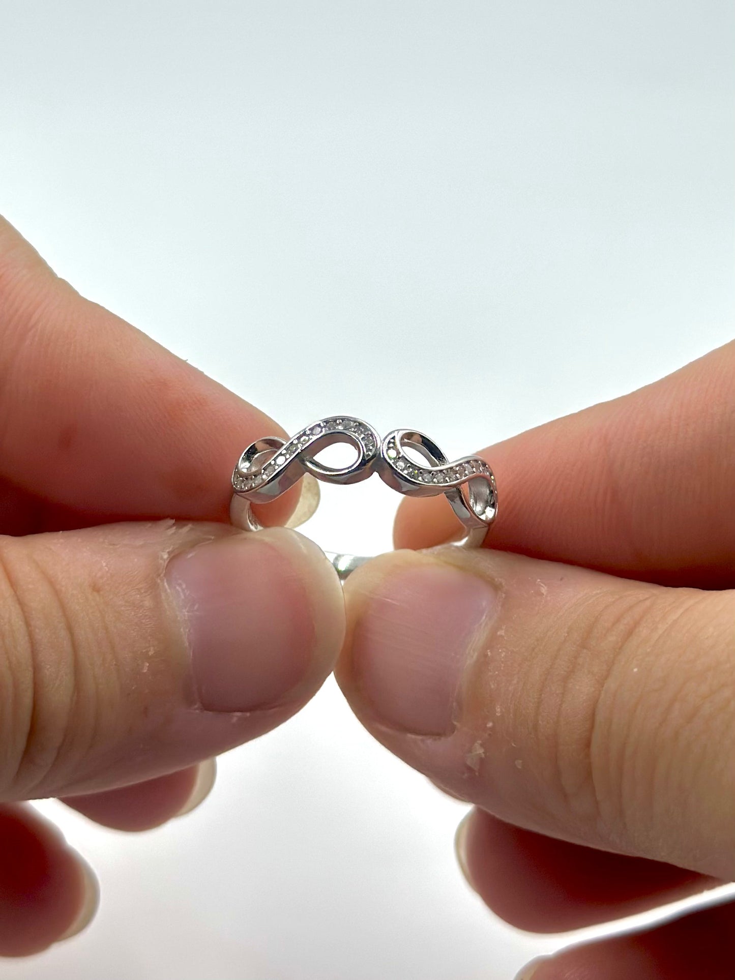 Zircon studded, infinity shaped sterling silver artisanal ring