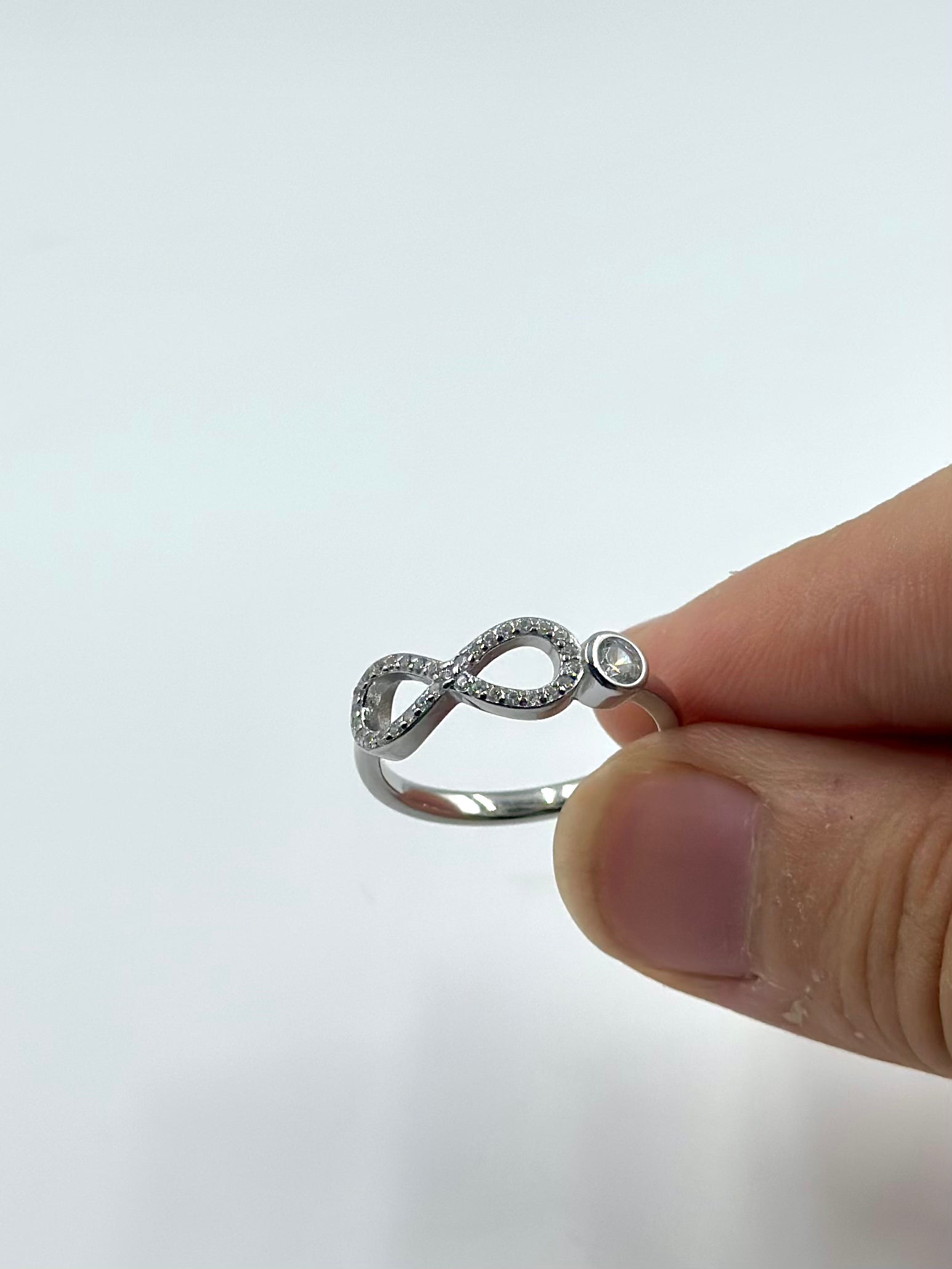 Zircon studded, infinity shaped sterling silver artisanal ring